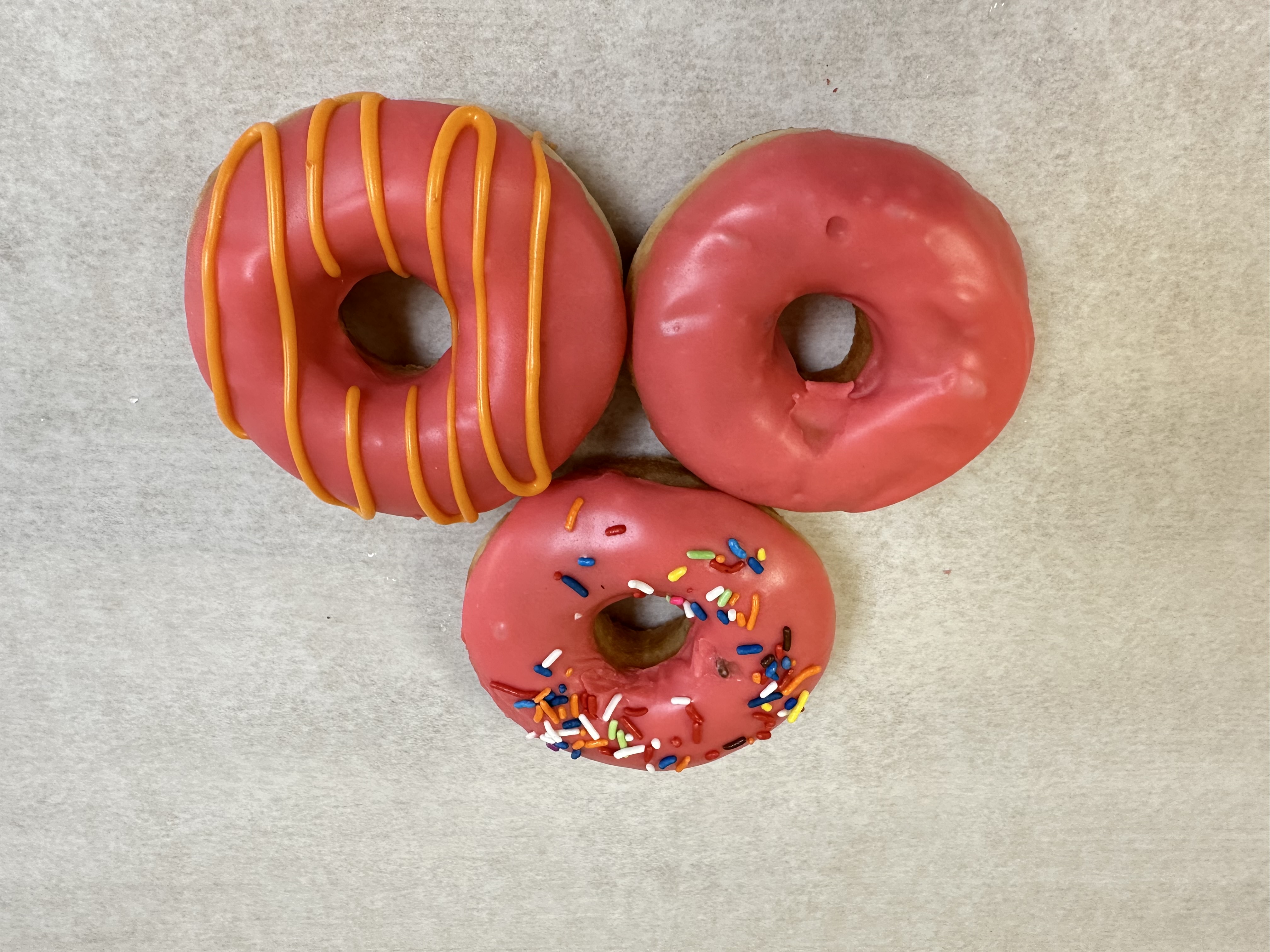 Fresh strawberry frosted donuts